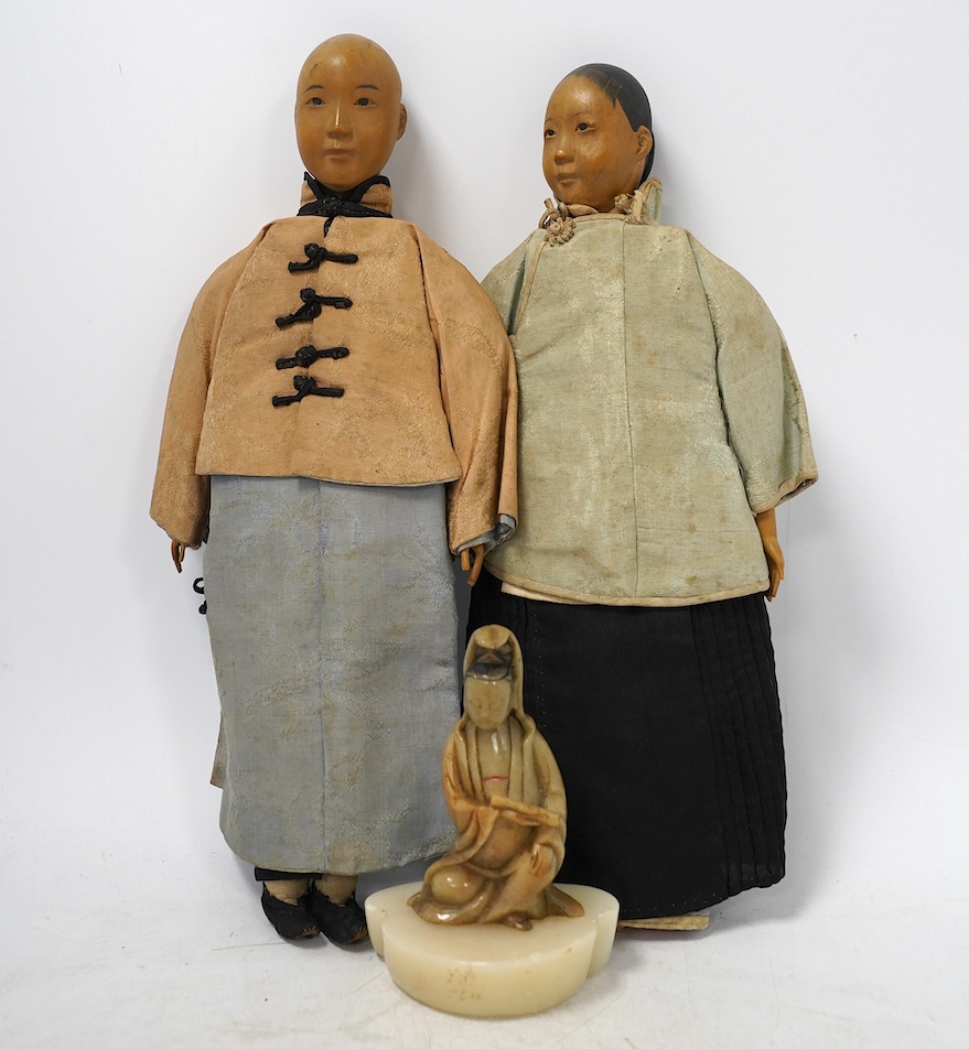 Two Chinese Door of Hope missionary wood and fabric dolls, early 20th century, 30cm, and a Chinese soapstone figure of Guanyin, 18th/19th century, 10.5cm. Condition - fair, feet missing to one and other minor wear etc.